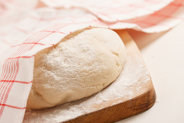 Dough on wooden board