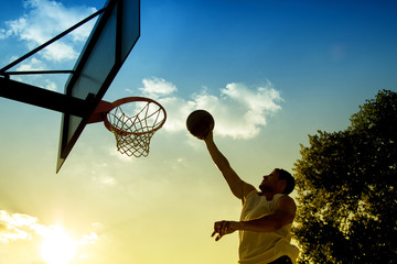 Basketball player silhouette at sunset