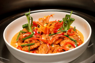 bowl of curry chicken cooked with coconut milk