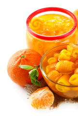 Orange jam with zest and tangerines, isolated on white