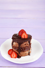 Chocolate cake with strawberry on wooden table close-up