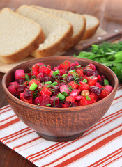 Beet salad in bowl on table close-up