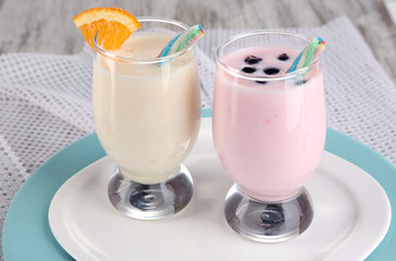 Delicious milk shakes with orange and blackberry