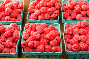 Fresh red raspberries on display at the market