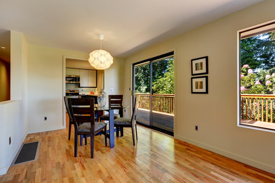 Large open space with dining room table and balcony door.