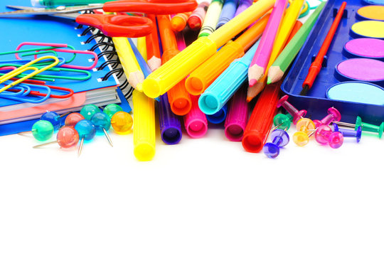 Border of colorful school supplies over white