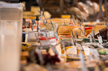 Grocery store. Cheese glass case closeup - obrazy, fototapety, plakaty