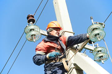 power electrician lineman at work on pole