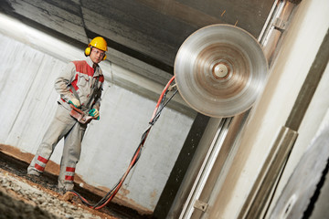 builder worker operating demolition machine