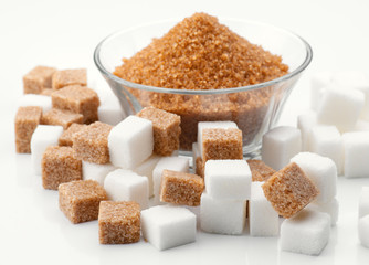 bowl of brown sugar and brown and white sugar cubes surround