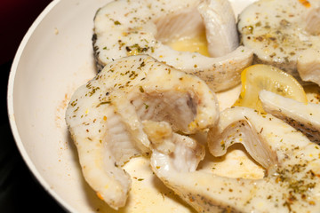 The fried fish on the frying pan