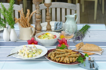 Fried sardines with potato salad, bread