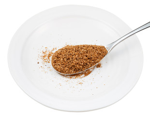 spoon of wheat bran on white plate