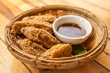 Crispy fried chicken strips with chili sauce.