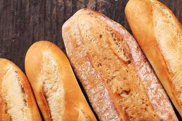 Top view of baguettes on wooden background