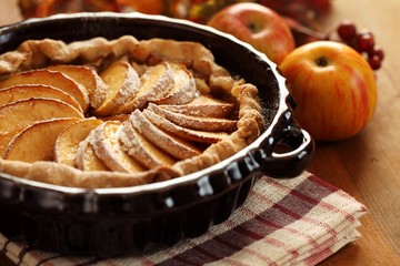 Arrangement of home-made apple pie and apples