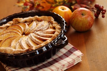 Arrangement of home-made apple pie and apples