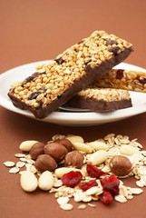 Granola bar, almonds, nuts,  cranberries, oat flakes and milk