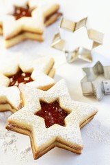 Christmas cookies and cookie cutters on white background.
