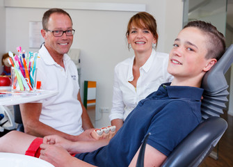 Counseling session  in a dentistry surgery with a young boy and 
