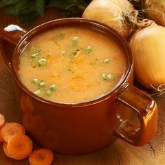 Detail of vegetable soup in pot and fresh food ingredients