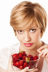 beautiful blond woman eating strawberries