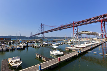 Fototapeta na wymiar 25th of April Bridge and marina at Lisbon