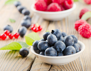 Blueberries and raspberry on wooden table