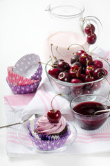 Cupcake with cherry on a wooden table. Selective focus