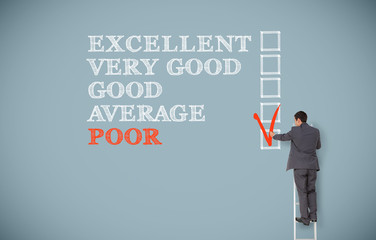 Man on ladder filling in survey on wall