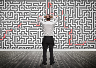 Confused businessman looking at a maze