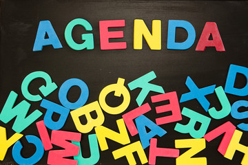 The word agenda written with colored letters