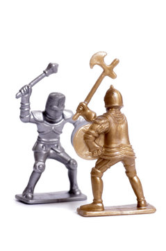 Fighting toy soldiers on a white background, knights