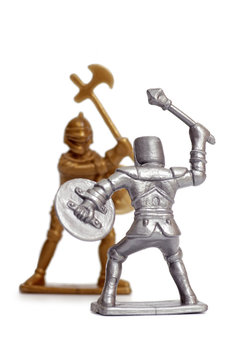 Fighting toy soldiers on a white background, knights