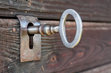 Closeup of an old keyhole with key