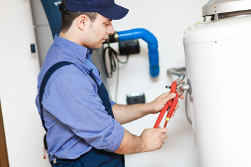 Plumber repairing a hot-water heater
