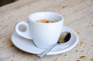 White espresso cup standing on the marble table