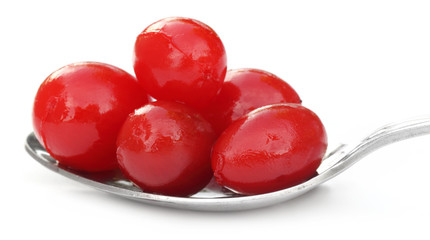 Processed cherry on a silver spoon