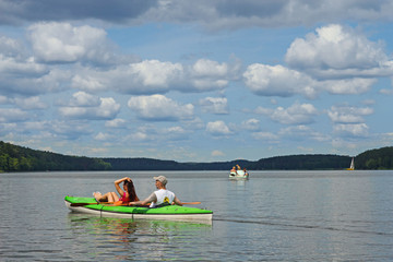 Young couple kayaking summertime  in the sunshine vacation