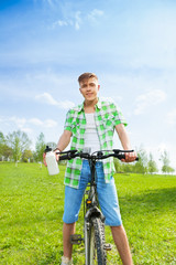 Young biker with bottle of water