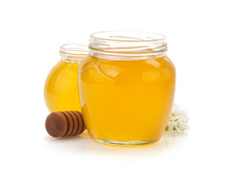 glass jar full of honey and stick