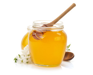 glass jar full of honey and stick