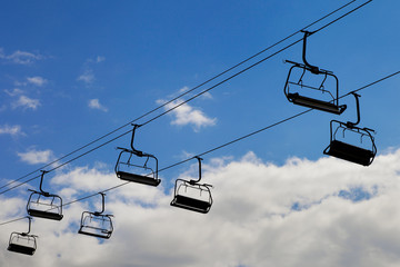chair lift, cableway on blue sky background