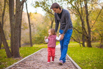 Young happy father with daughter in the park have fun