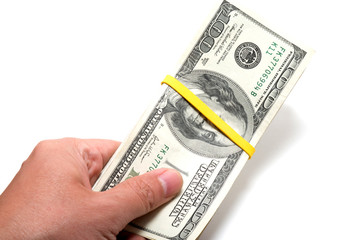 Hand holding a series of banknotes with 100 dollars on top