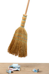 Broom sweep the euro on white background close-up