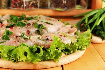 Chicken meat on wooden board,herbs and spices close-up