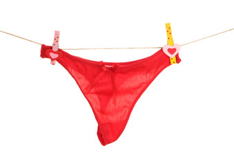 Women's panties hanging on rope isolated on white