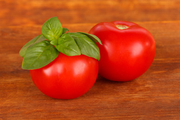 Tomato and basil on wooden background