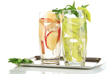 Glasses of fruit drinks with ice cubes isolated on white